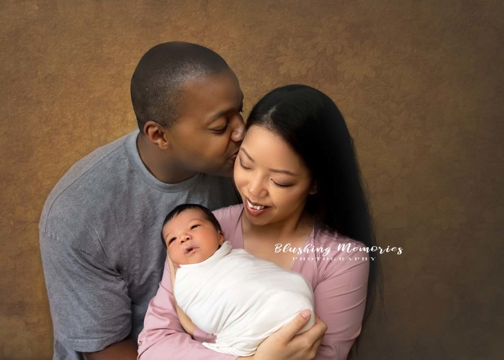 newborn baby boy in the mother arms for a family portrait session