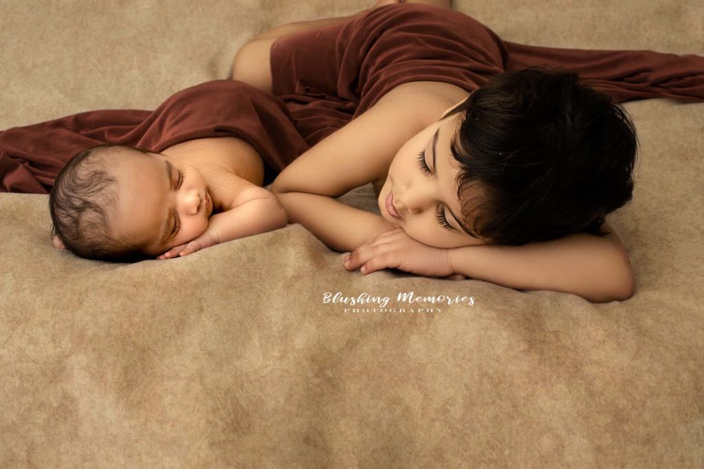 big boy and newborn baby boy sleeping position for studio posed photo session