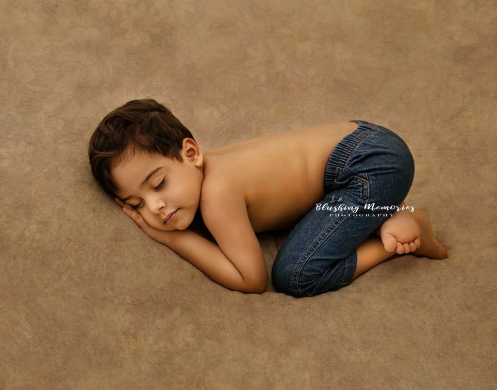 sleeping photo portrait session of a boy in the studio