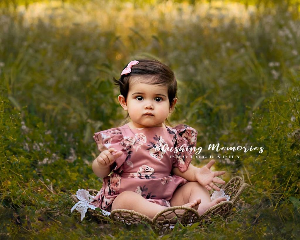 Outdoor photo portrait of a girl sitting in a basket