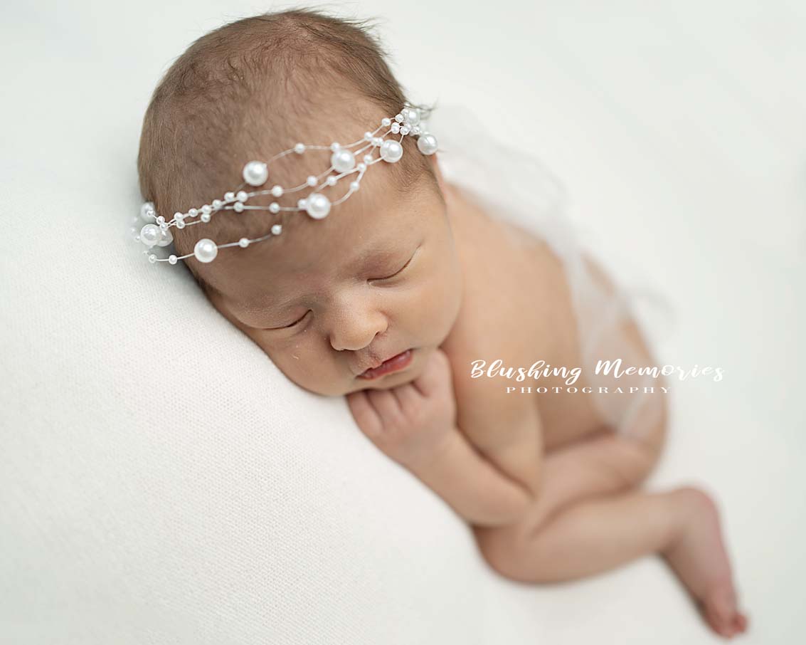 posed newborn baby girl photoshoot