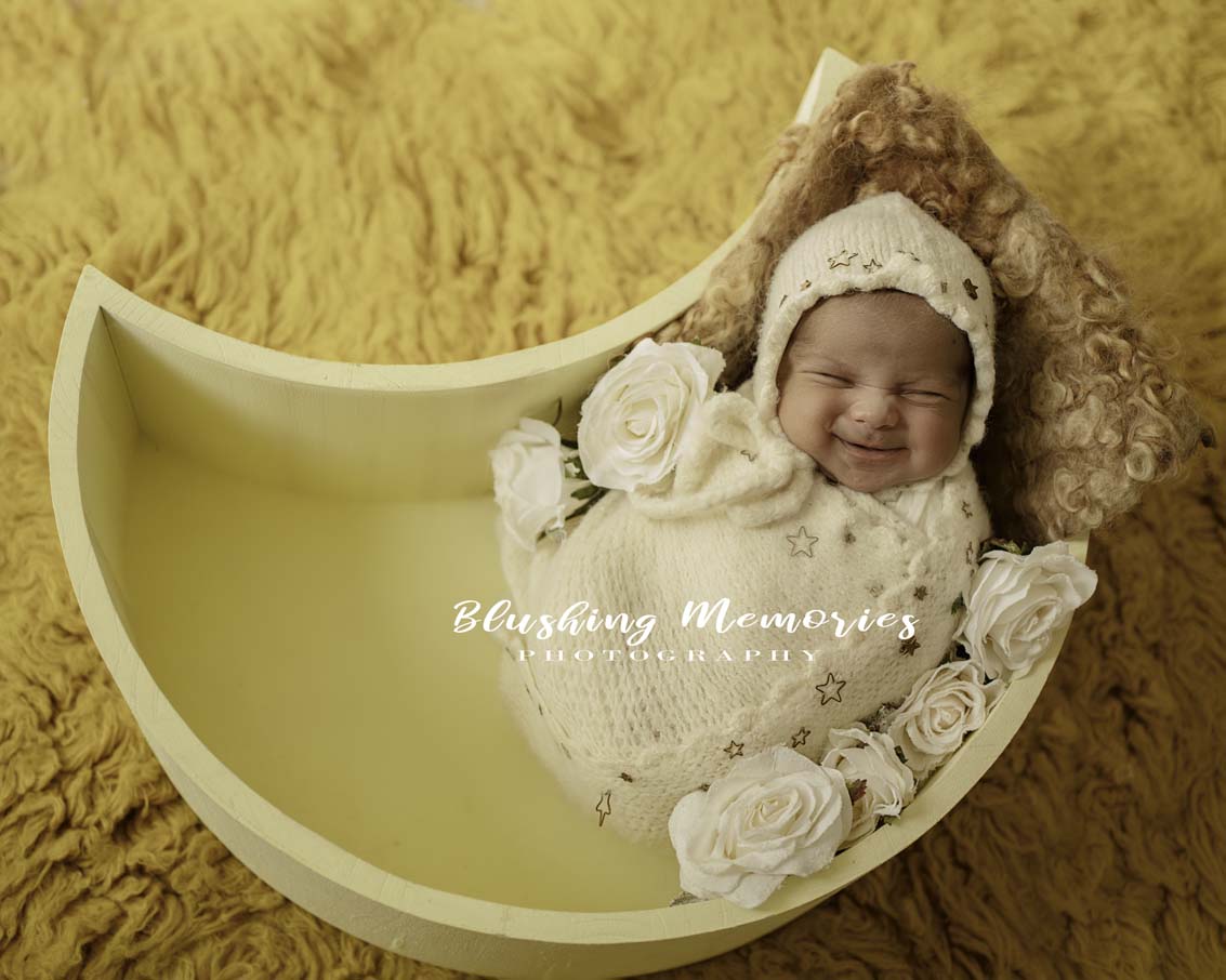 newborn baby girl photoshoot in a moon prop