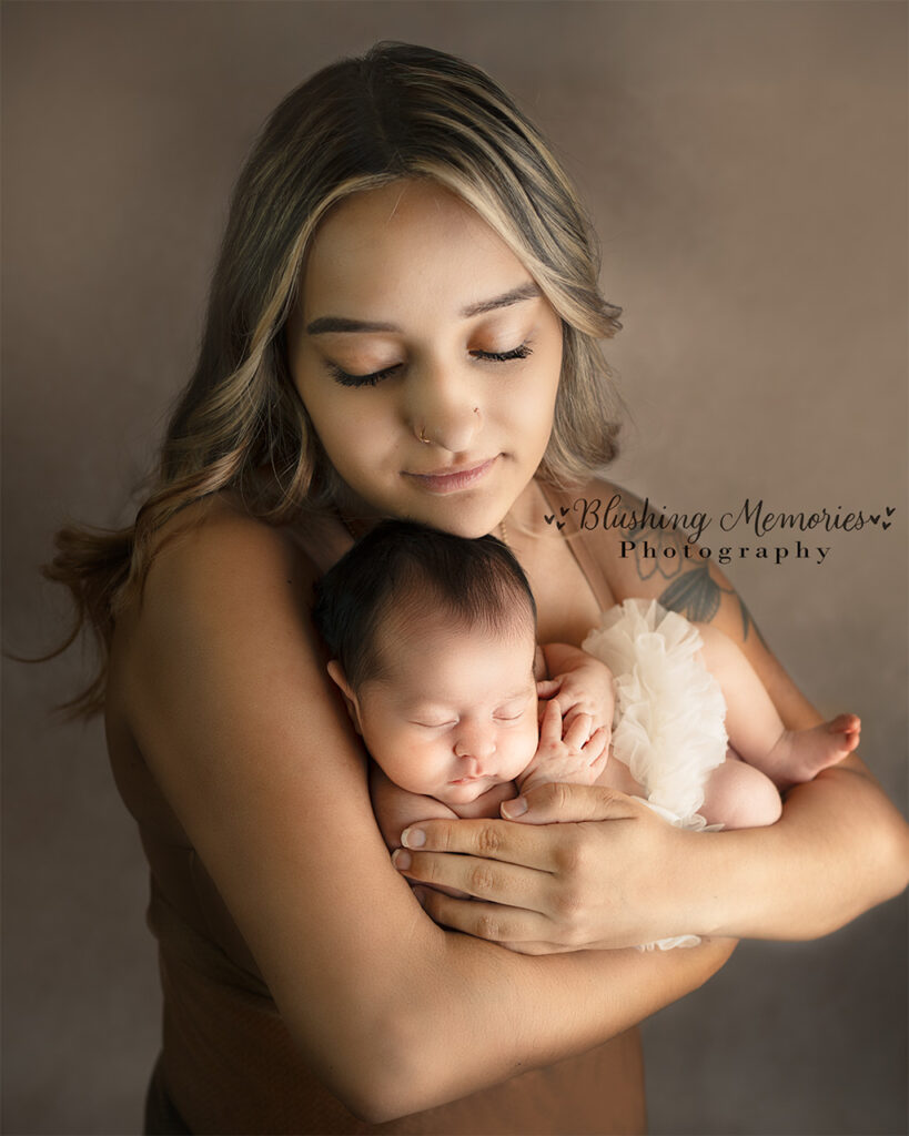 Mother with her one year old baby girl for newborn photo session