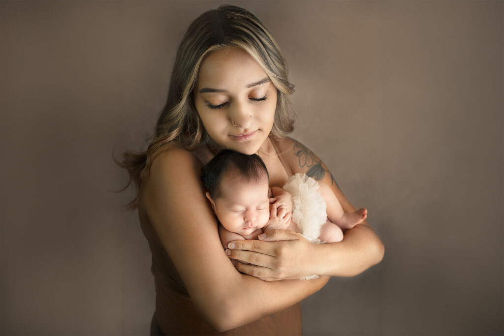 Mother with her baby girl for newborn photo session