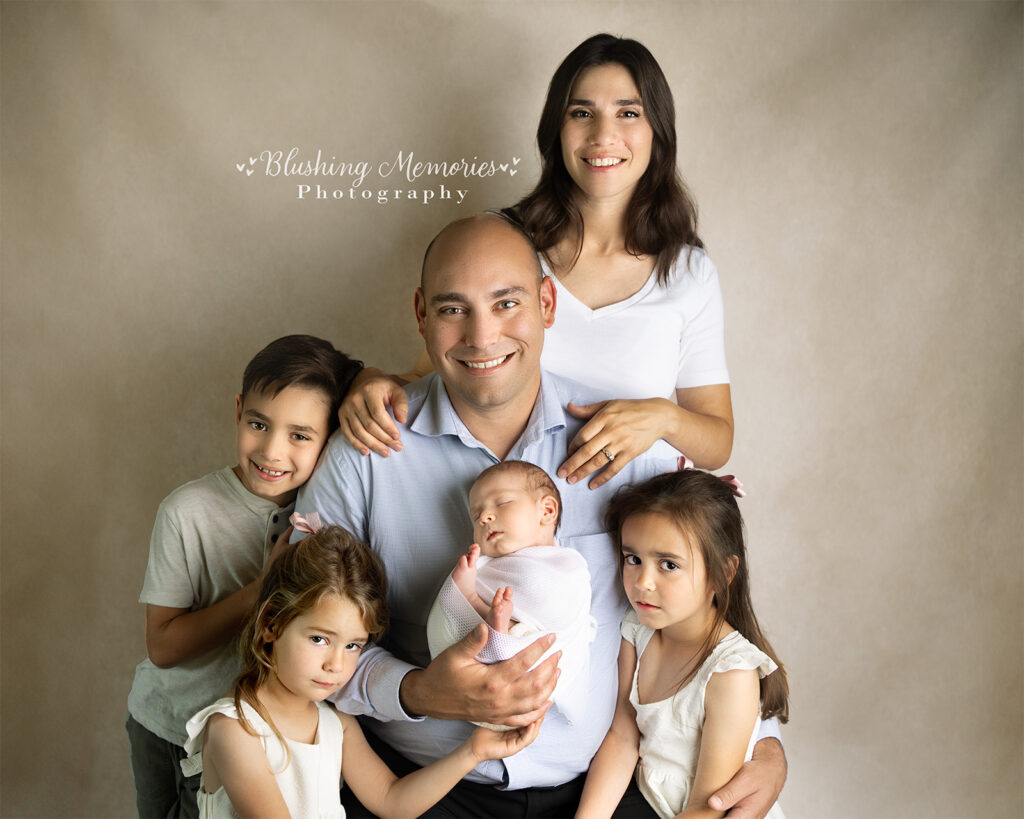 With Siblings - baby boy wrapped in white swaddle, photographed by Blushing Memories Photography in El Dorado Hills