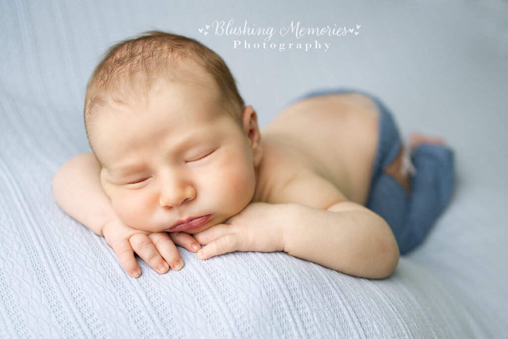 newborn babyboy posed hand on chins-blushing memories studio_folsom