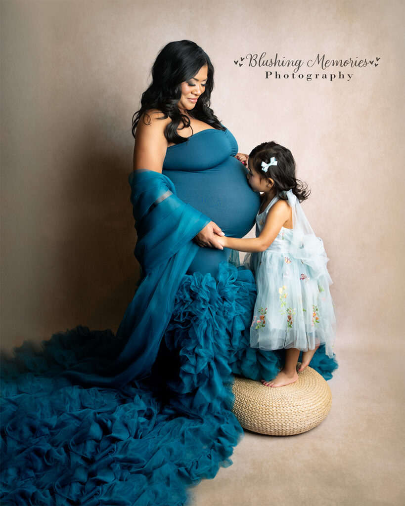 Maternity portrait of an expecting mother and her young daughter sharing a tender moment in a studio session – Blushing Memories Photography, El Dorado Hills, Folsom, Sacramento, Bay Area