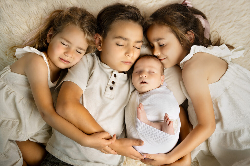 newborn baby boy with the sibling on the flokati for the studio portrait in el dorado hills photography studio