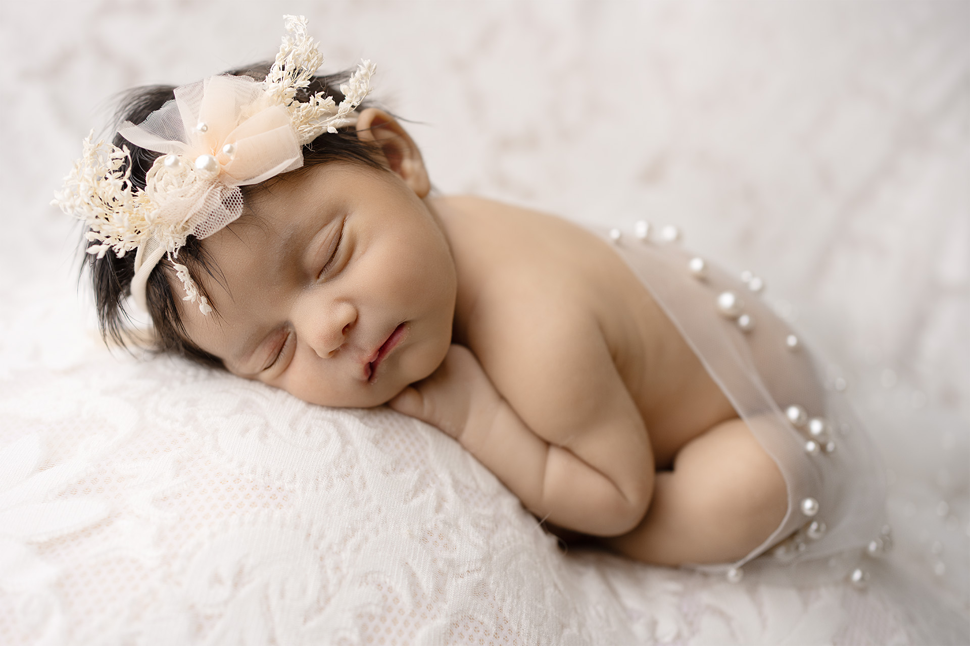 Elegant newborn baby girl photoshoot in Folsom CA with pearl wrap and floral headband by Blushing Memories studio